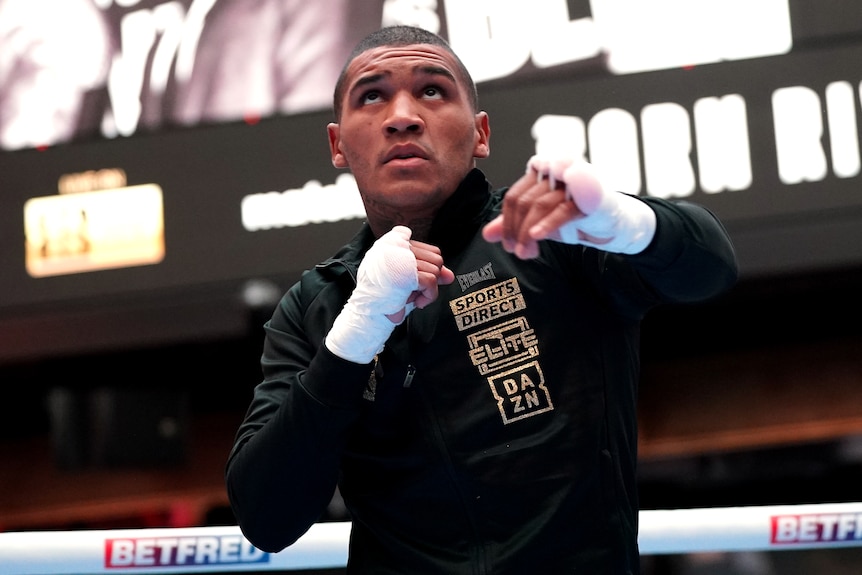 Boxer Conor Benn shadow boxes while wearing hand wraps.