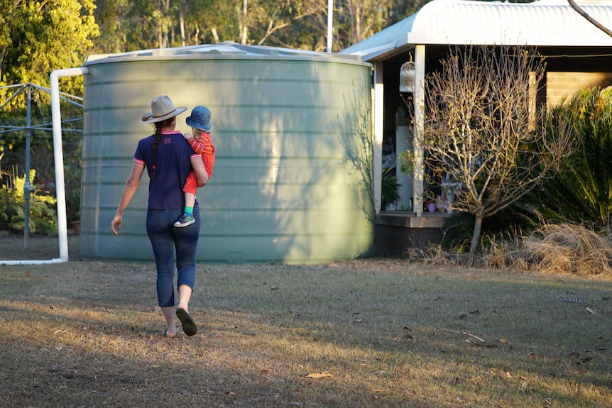 Tracy walks towards the tank.