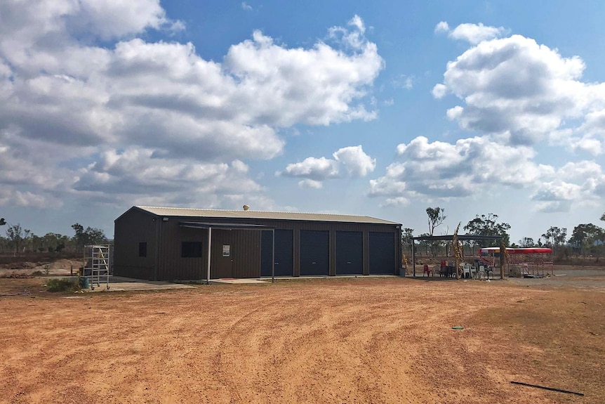 A large brown aluminium shed on a rural property