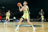A basketballer prepares to shoot a ball.