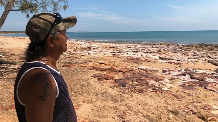 Indigenous man looks out to sea