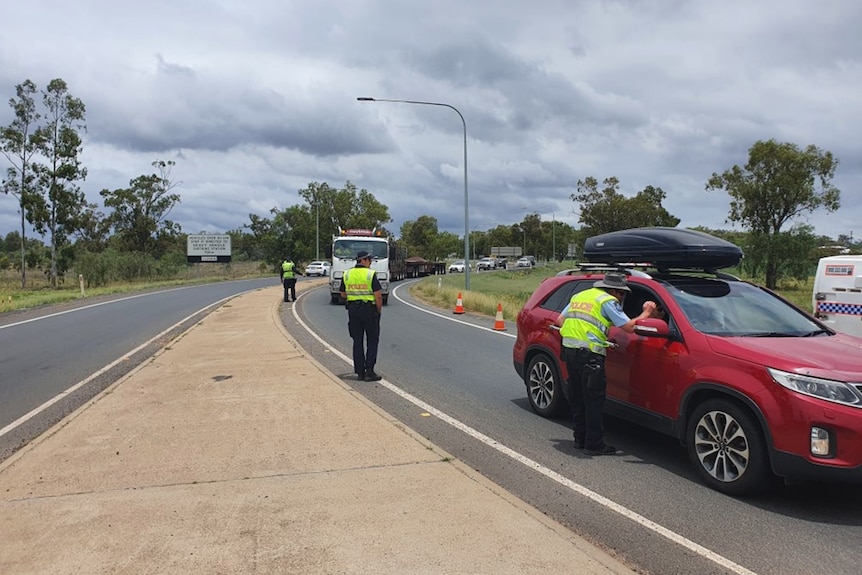 Police checking a line of cars