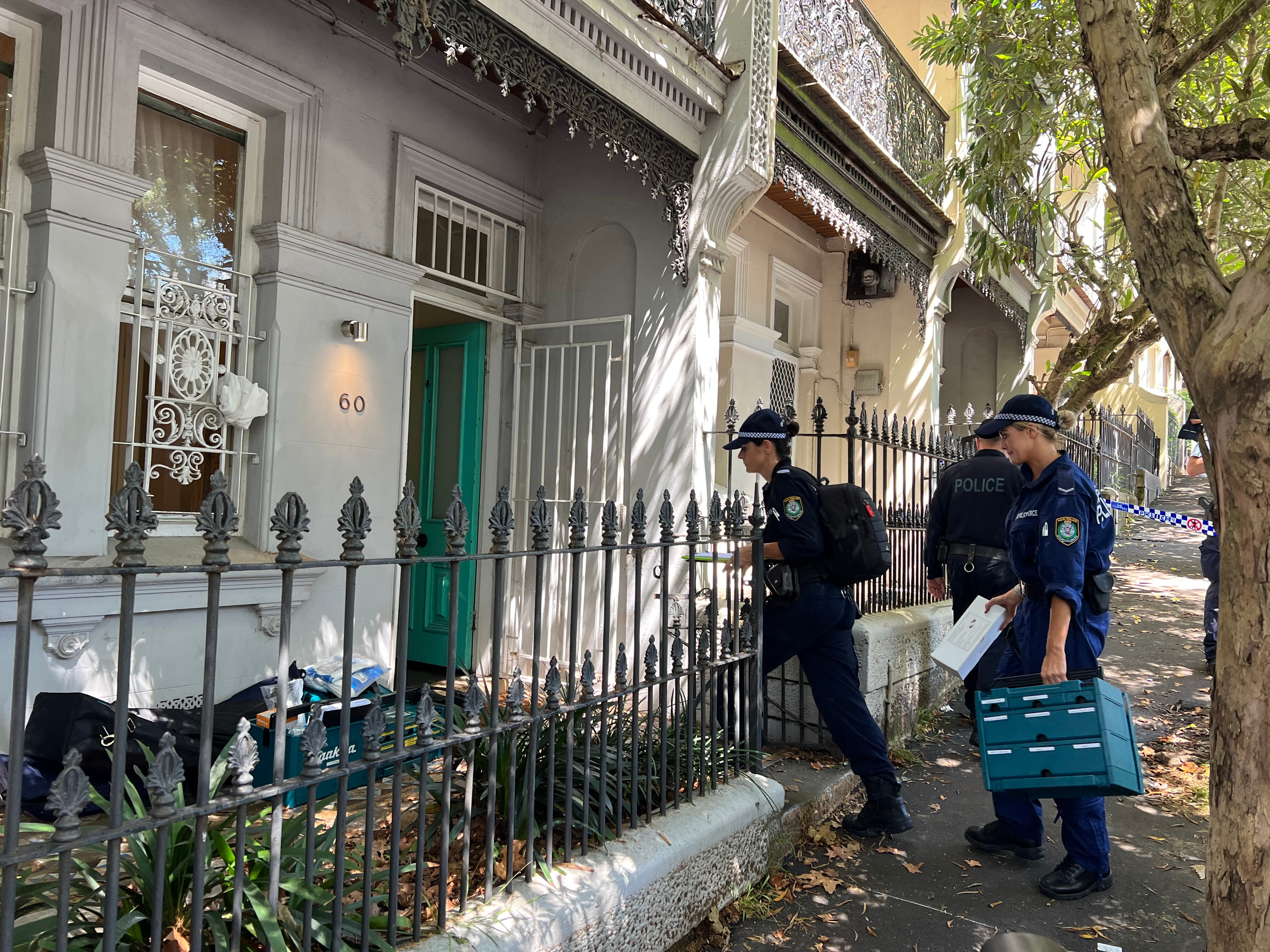 Police officers enter a house