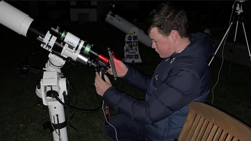 Lachlan Wilson using his camera and telescope.