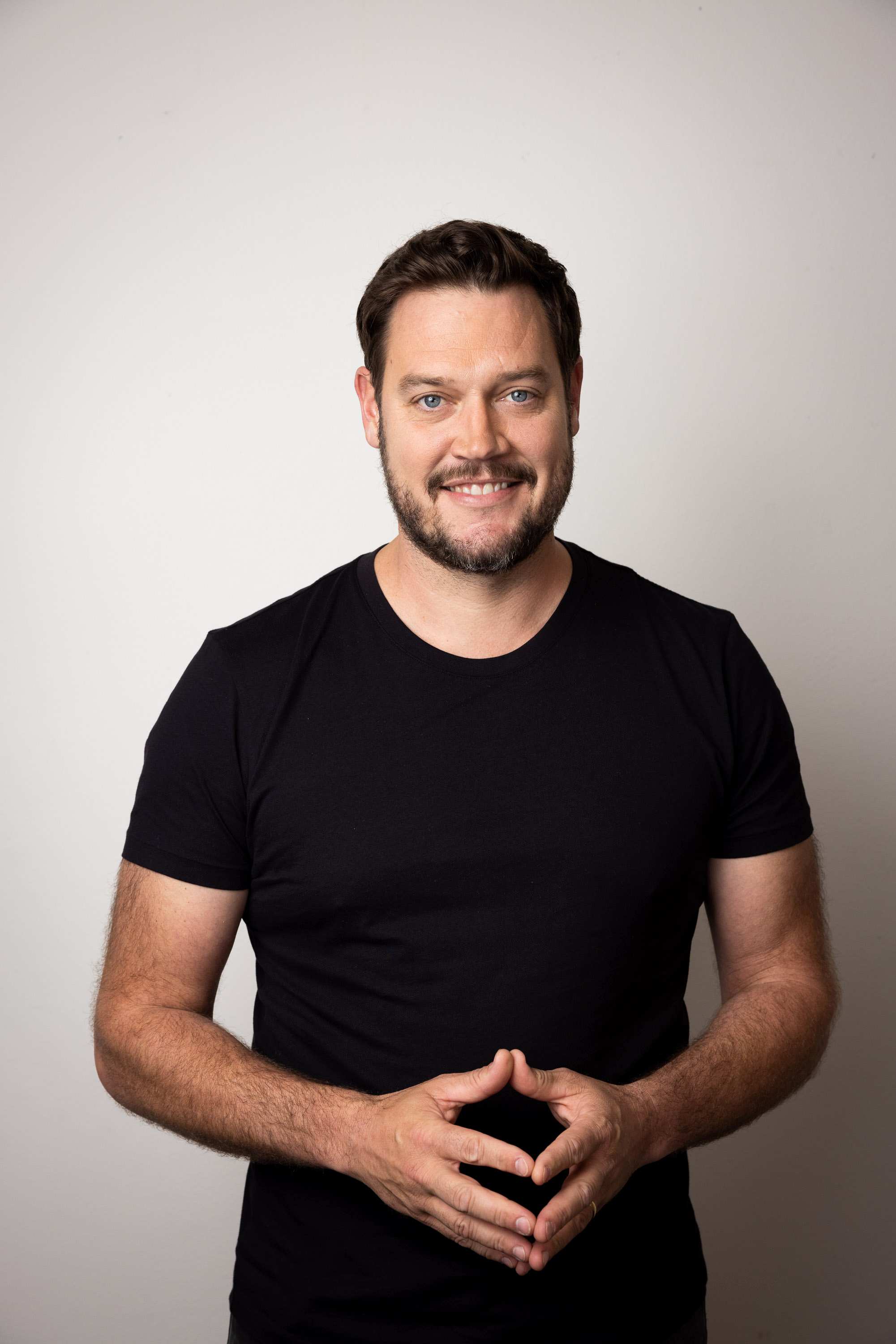 A white male with a beard smiling