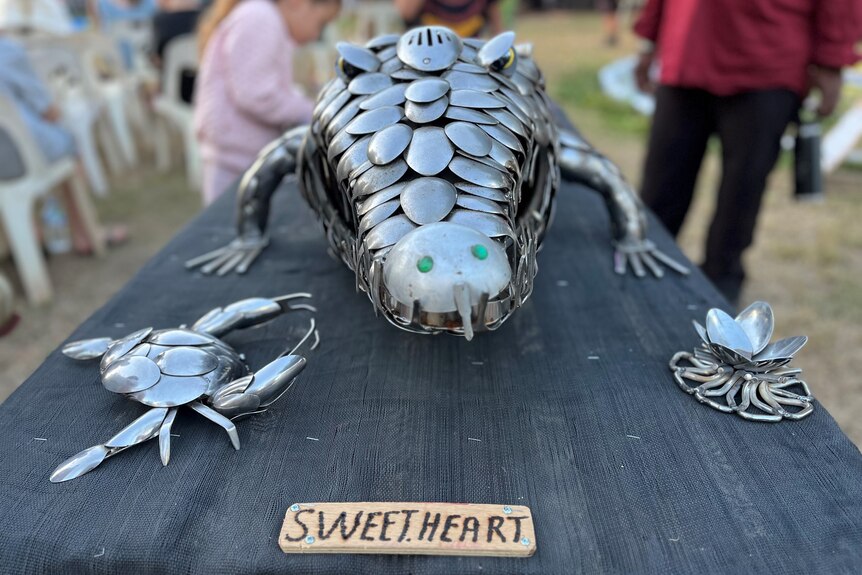 a crocodile made out of spoons