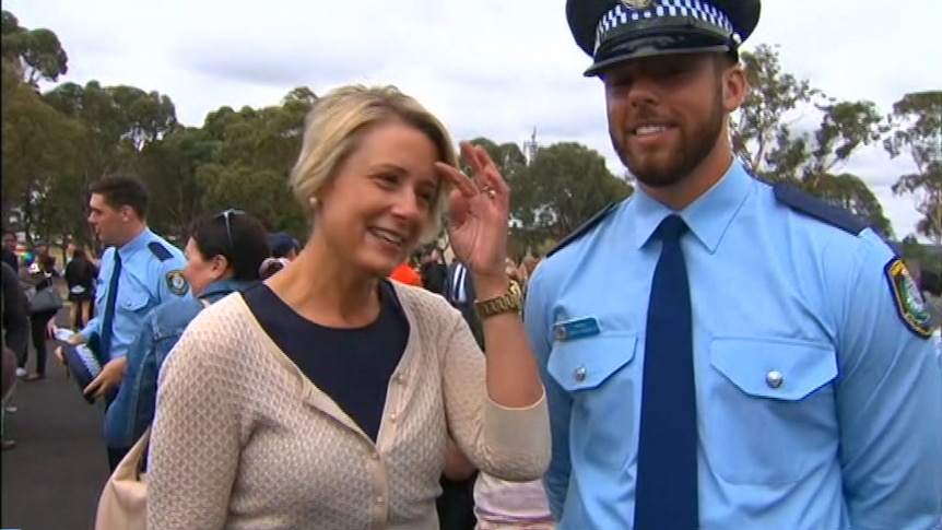 Man in police officer uniform stands with woman