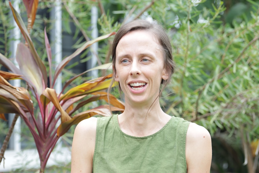 A young white woman wearing a green shirt