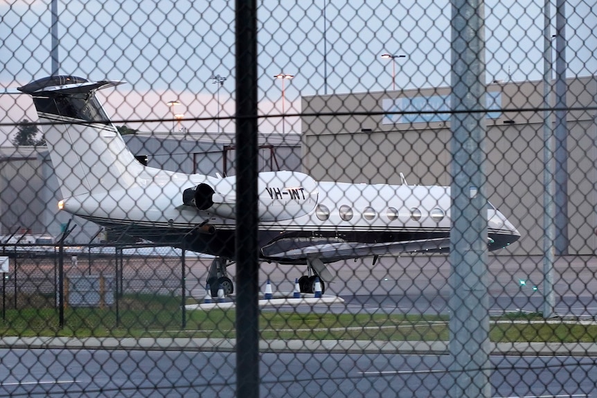 A plane parked at an airport terminal.
