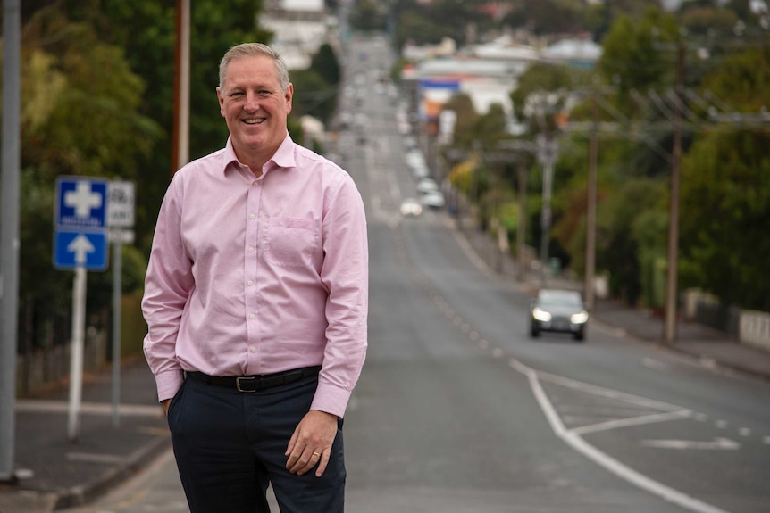 Troy Bell stands alongside  road