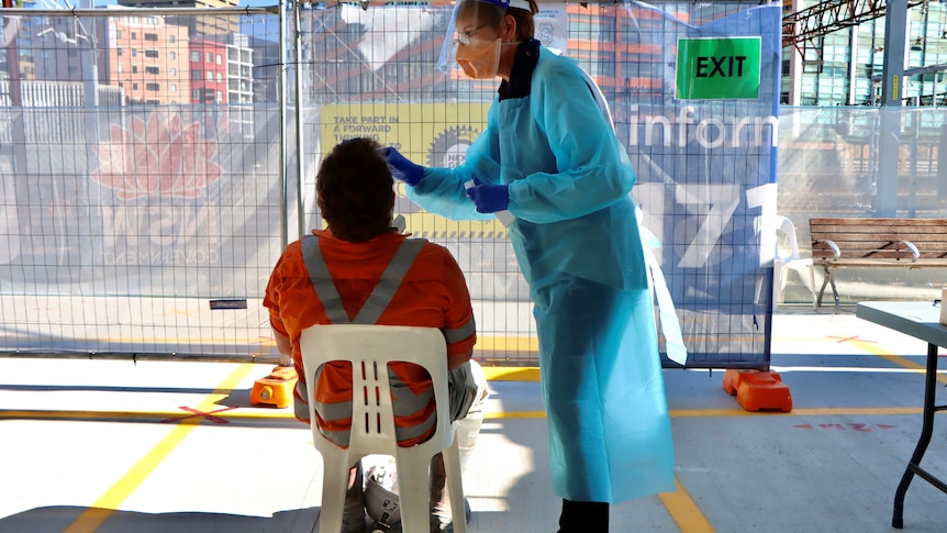 a sign saying rapid antigen testing at a building site