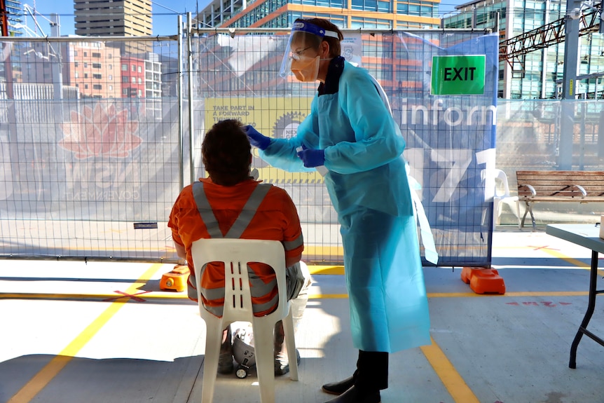 a sign saying rapid antigen testing at a building site