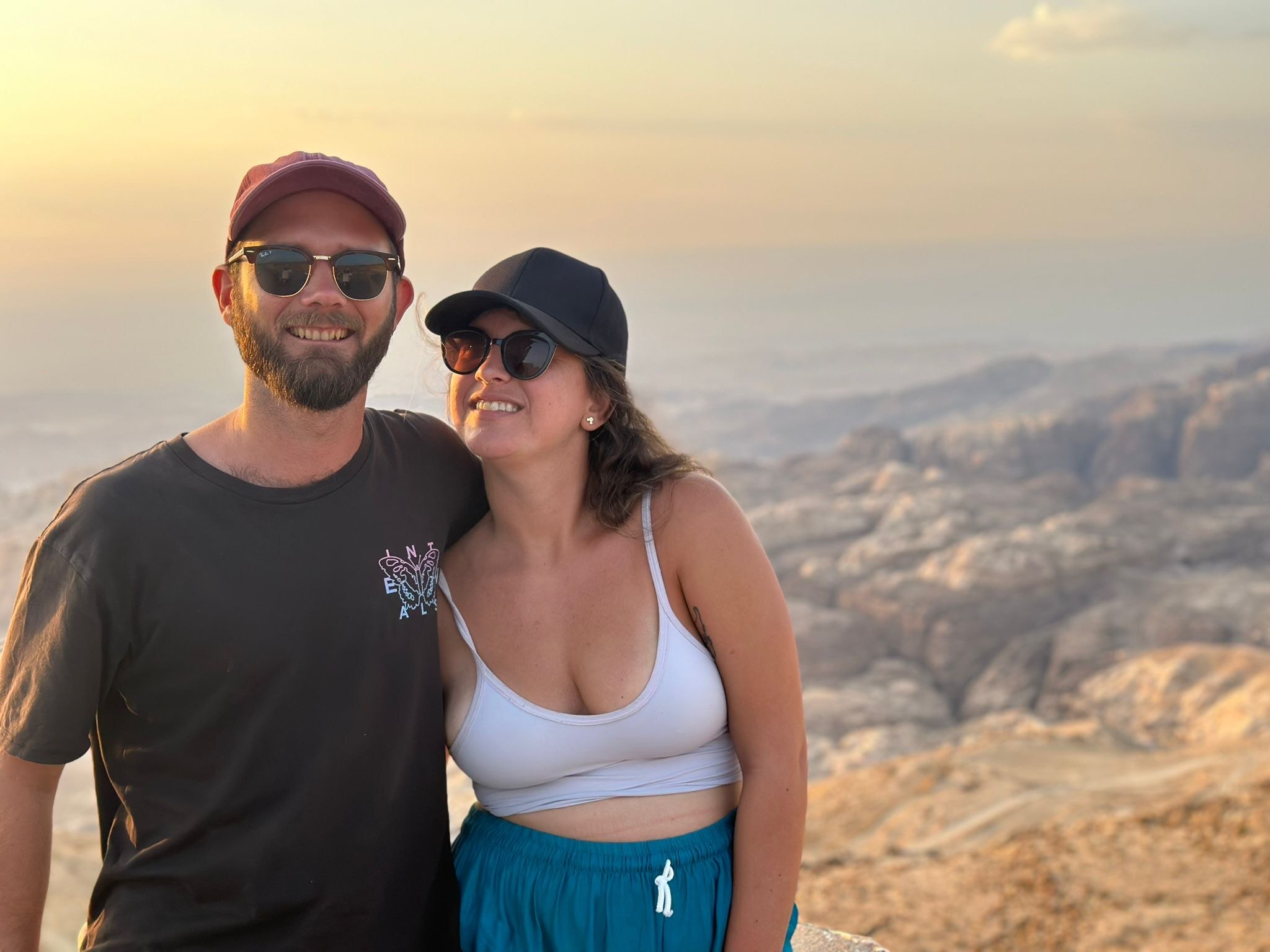 Couple standing on a rocky landscape.