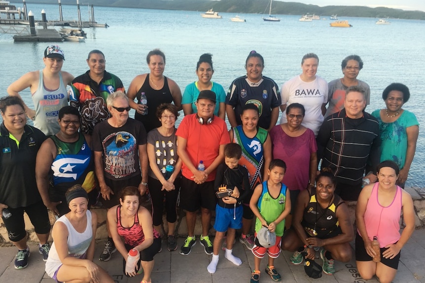 Men, women and children smiling after a running session on the Thursday Island foreshore