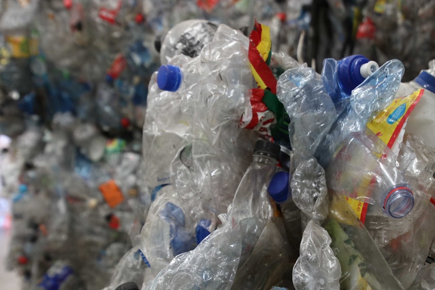 A close-up shot of crushed plastic bottles at a waste recovery centre.
