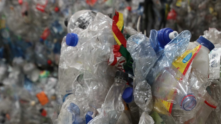 A close-up shot of crushed plastic bottles at a waste recovery centre.