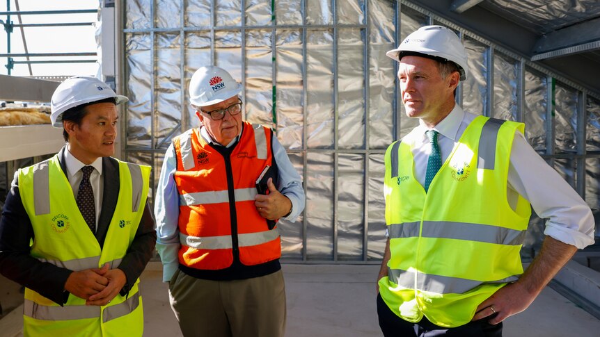 Three men in high vis building gear and hard hats
