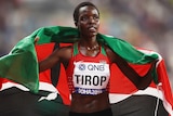 Agnes Tirop wraps herself in the Kenyan flag.