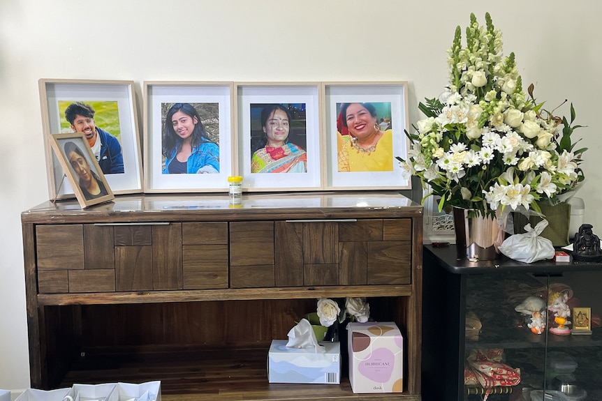 Framed photos of three women and one man.