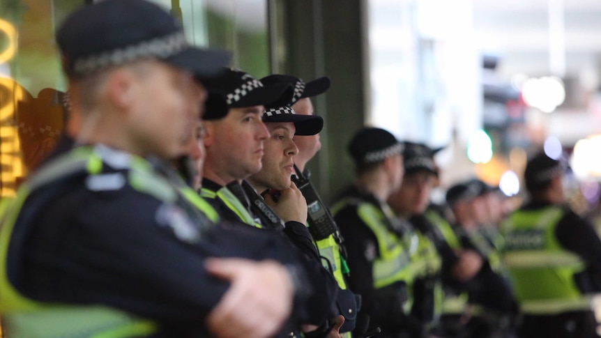A line of uniformed police in central Melbourne.