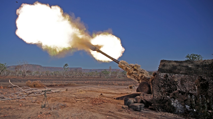 A missile dramatically fires from a cannon in an outback setting.