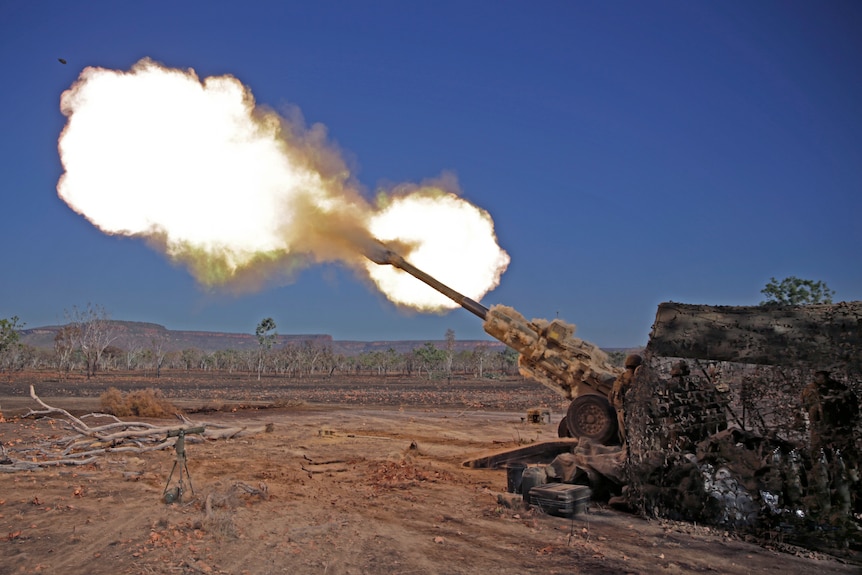 A missile dramatically fires from a cannon in an outback setting.
