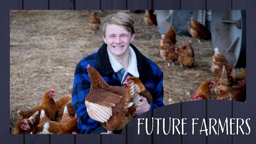A boy smiles while crouching beside a chicken