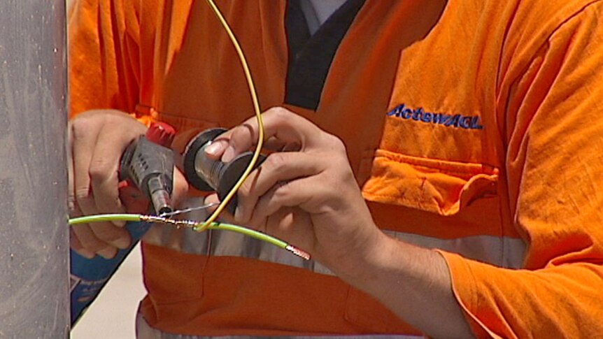 Worker fixes an electrical cable