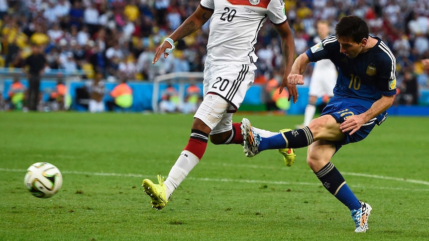 Messi gets a shot away under pressure from Boateng