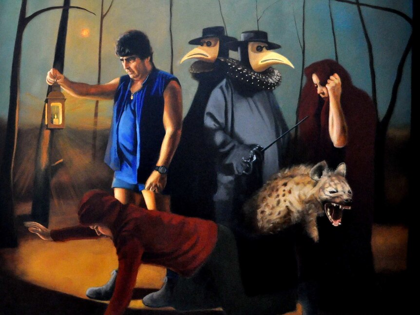 Portrait of Tony Galati with two men in cloaks, a man in a hoodie on all fours, a wild pig and a woman in a dark red hood