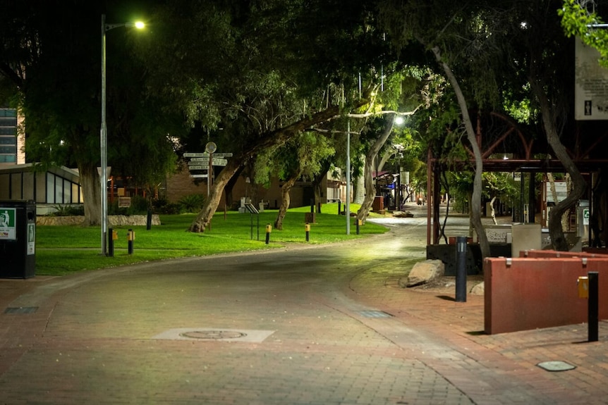 An empty street pictured at night lit up by street lights