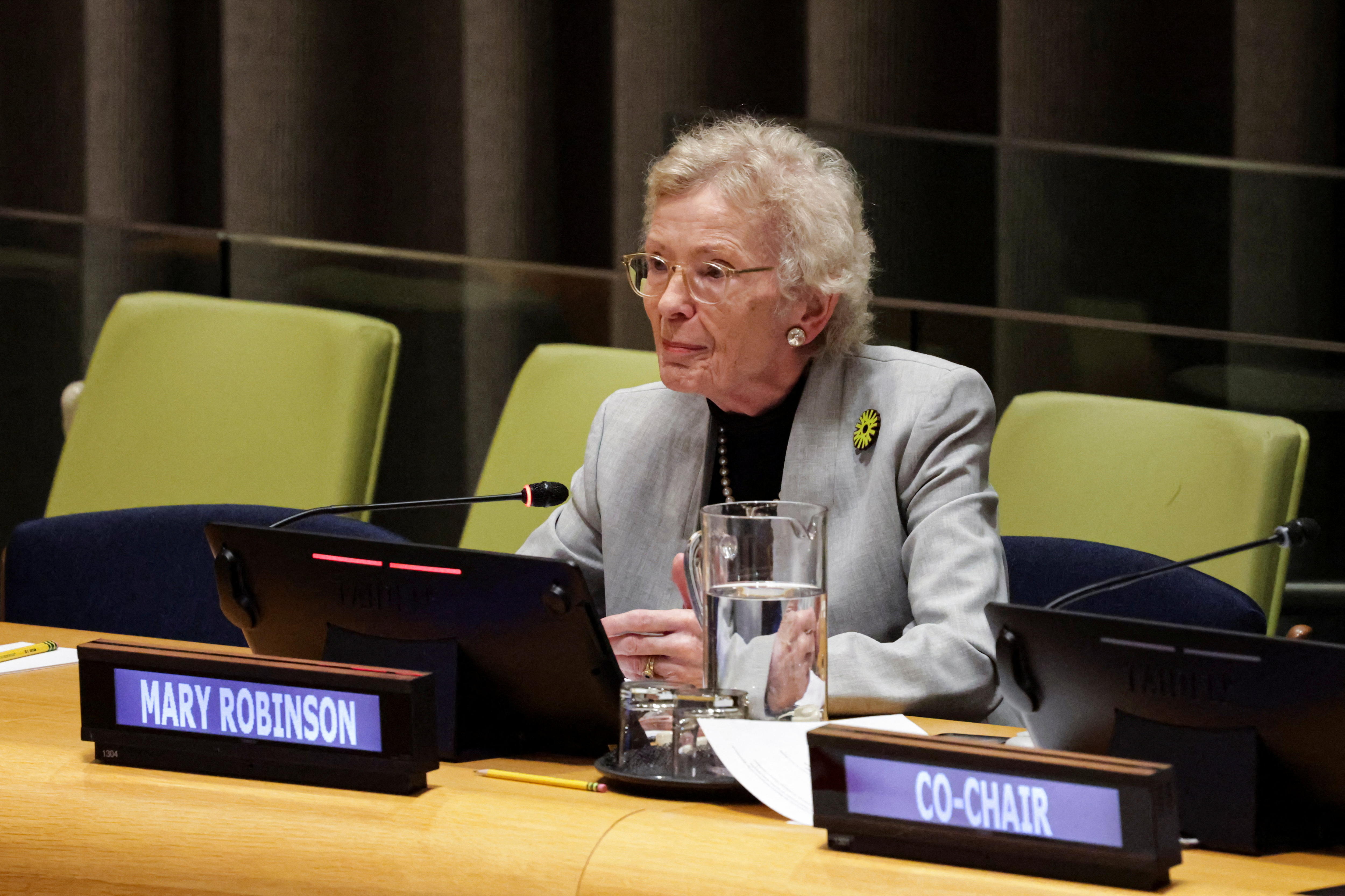 A woman sits in from of a name tag that says Mary Robinson 