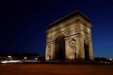 The Arc De Triomphe alight in front of a night sky 