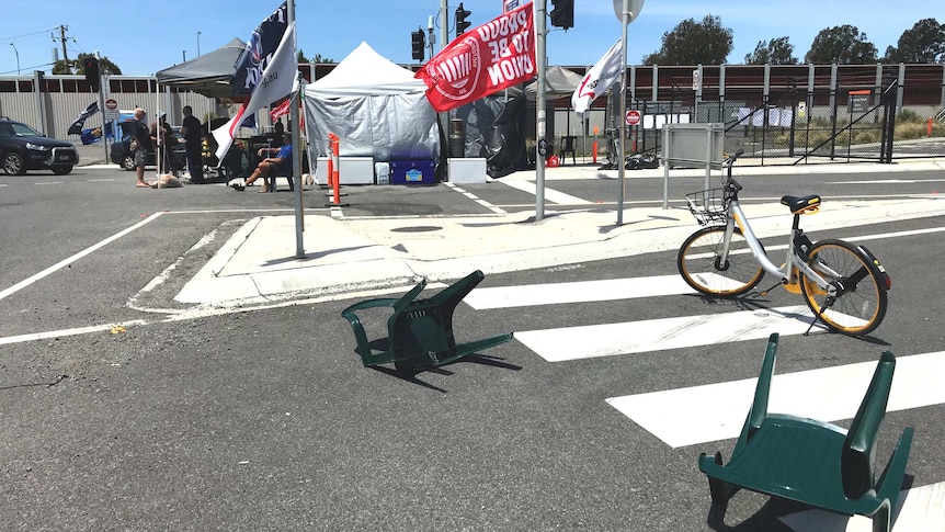oBikes and plastic chairs form part of a union blockade of Webb Dock in Melbourne.