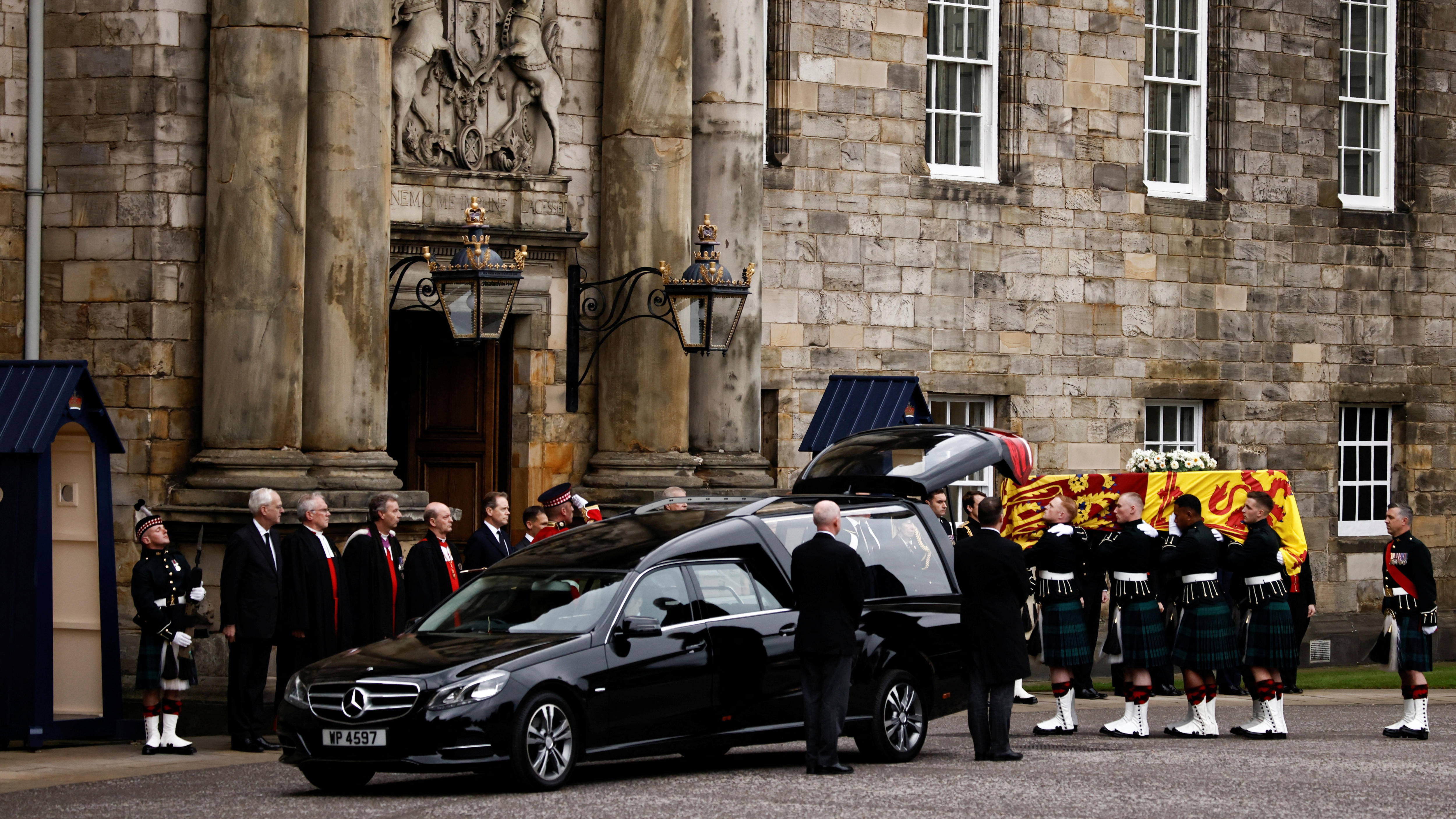 Pallbearers carry the coffin of Queen Elizabeth II as the hearse arrives at the Palace of Holyroodhouse.