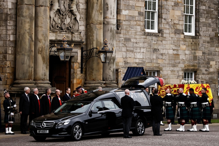 Pallbearers carry the coffin of Queen Elizabeth II as the hearse arrives at the Palace of Holyroodhouse.