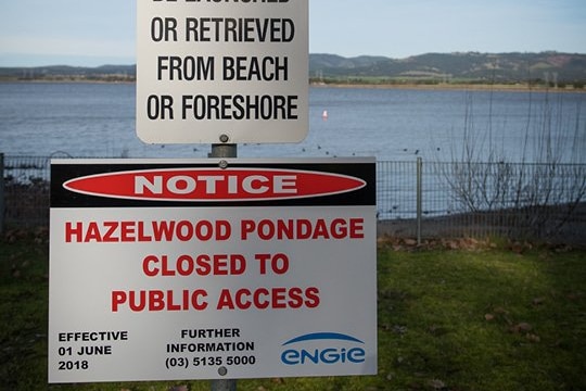 A sign saying the pondage area behind it is closed to the public