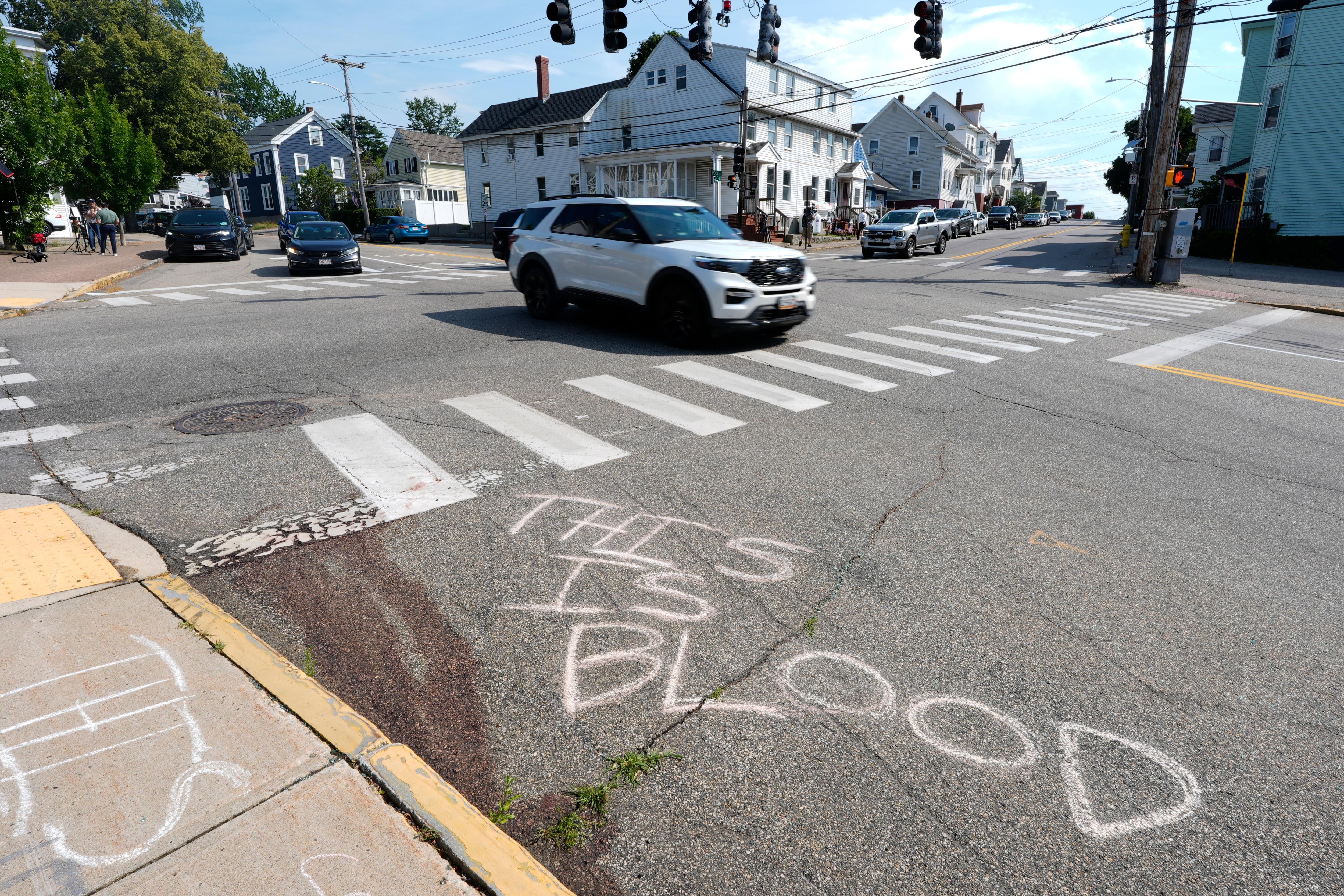 Blood is seen on the pavement near the scene of a shooting involving ICE.