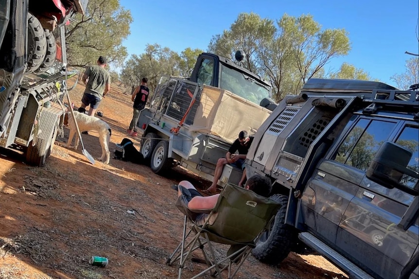 Cars and chairs at a camping set up in outback Queensland.