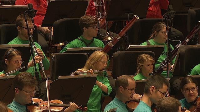 Musicians play wind instruments in orchestra