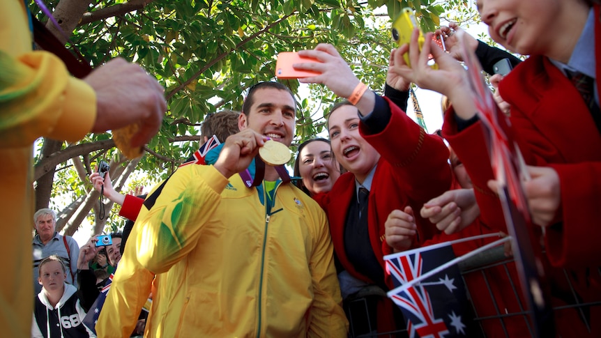 Flatwater canoe/kayak gold medallist Tate Smith with young fans during the Australian Olympic Athletes welcome home parade.