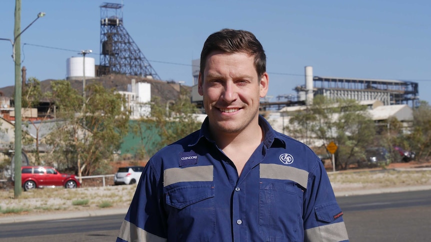 Huw Wright standing in front of Mount Isa Mines