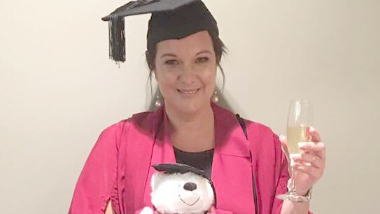 Mimi Dewalheyns in her graduation robe and hat