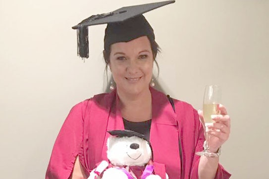 Mimi Dewalheyns in her graduation robe and hat