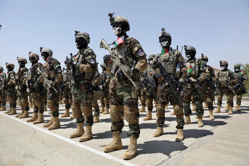 New Afghan Army special forces members attend their graduation ceremony wearing skull masks and military gear.