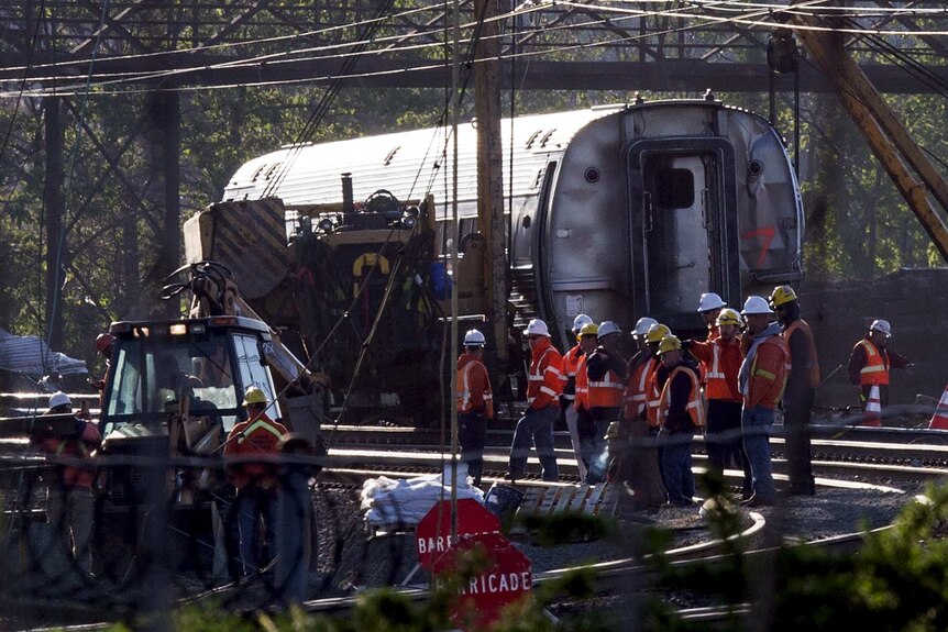 Officials work at the site of a derailed Amtrak train in Philadelphia