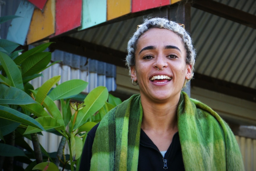 Close up photo of a woman smiling and looking at the camera 