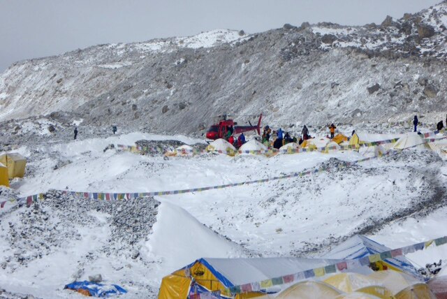 A helicopter comes to collect injured climbers at Mount Everest base camp.