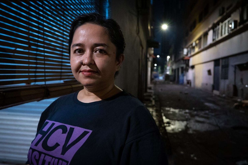 Photo shows Malaysian woman Yatie Jonet standing in a Kuala Lumpur alley.