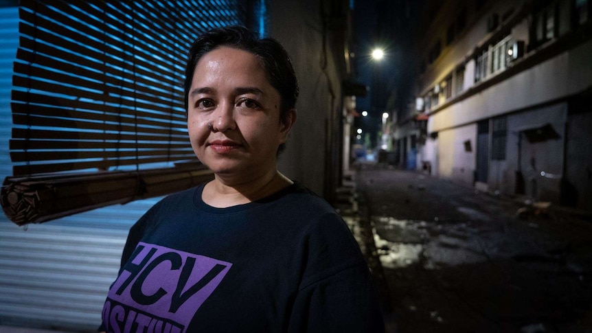 Photo shows Malaysian woman Yatie Jonet standing in a Kuala Lumpur alley.
